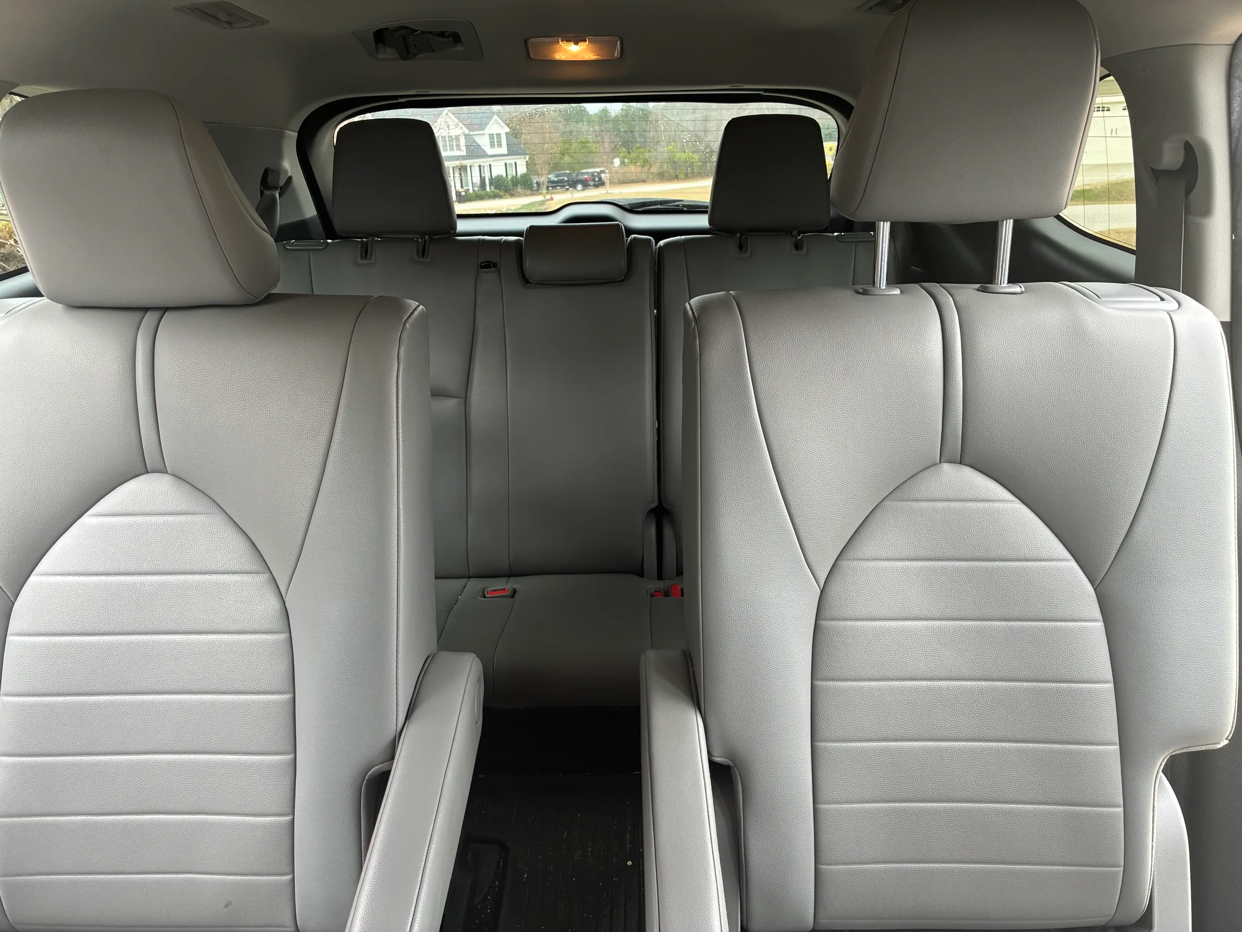 Freshly detailed third-row interior of a Toyota Highlander with clean seats and carpet